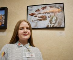 Photographer Anastasia Golosna poses with her photograph “Reflections of Autumn” at the Artist Reception at Rancho Cordova City Hall. Photo by Rick Sloan