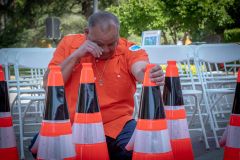 A Caltrans employee holds an orange cone while honoring the 189 fallen highway workers that have died since 1921. Photo courtesy of Caltrans 