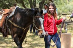 A Girl Scout walks with a horse at the 2019 Outdoor Adventure Campout. Photo courtesy of Girl Scouts Heart of Central California