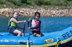 Two Girl Scouts paddle in a raft at the 2019 Outdoor Adventure Campout. Photo courtesy of Girl Scouts Heart of Central California