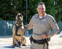 Officer Jeff Bosnich with one of this year’s CHP canine graduates. Photo courtesy of CHP